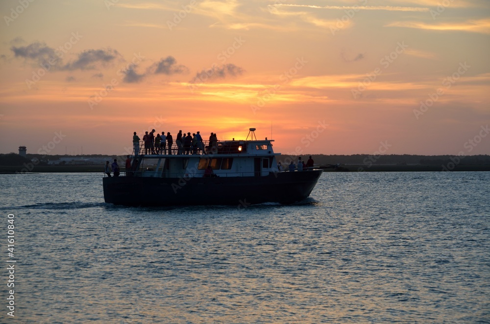 people silhouetted on a sunset cruise florida
