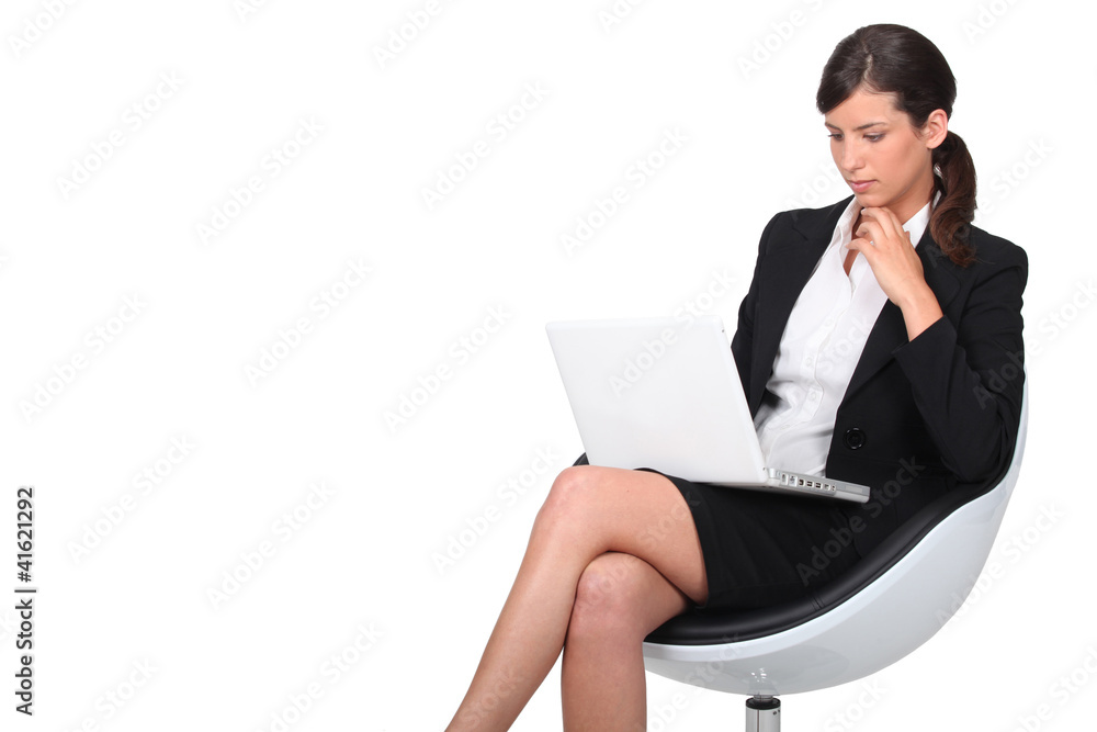 Woman sitting in armchair with computer Woman sitting in armchair with computer