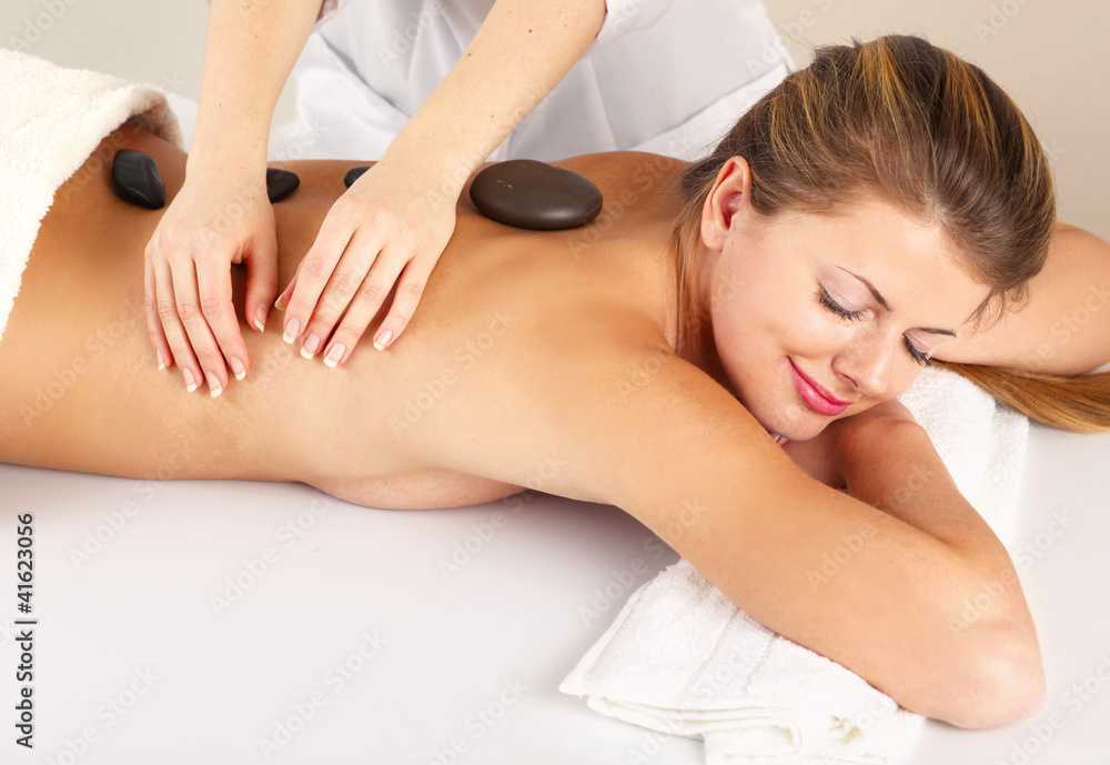 Obraz premium An attractive woman getting spa treatment, isolated on white