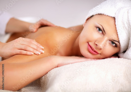 An attractive woman getting spa treatment, isolated on white