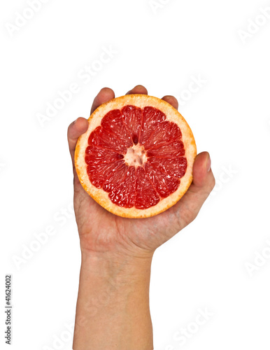 Half of grapefruit in female hand. Isolation.