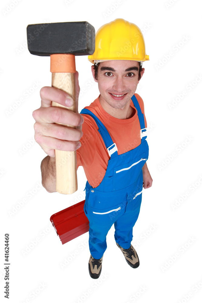 Young mason displaying lump hammer Young mason displaying lump hammer