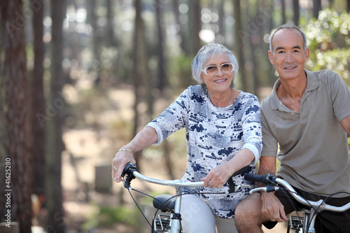 A mature couple on a bike ride. © auremar