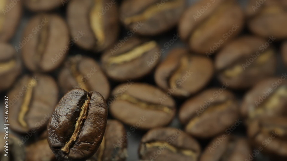 Closeup of coffee beans with focus on one Closeup of coffee beans with focus on one