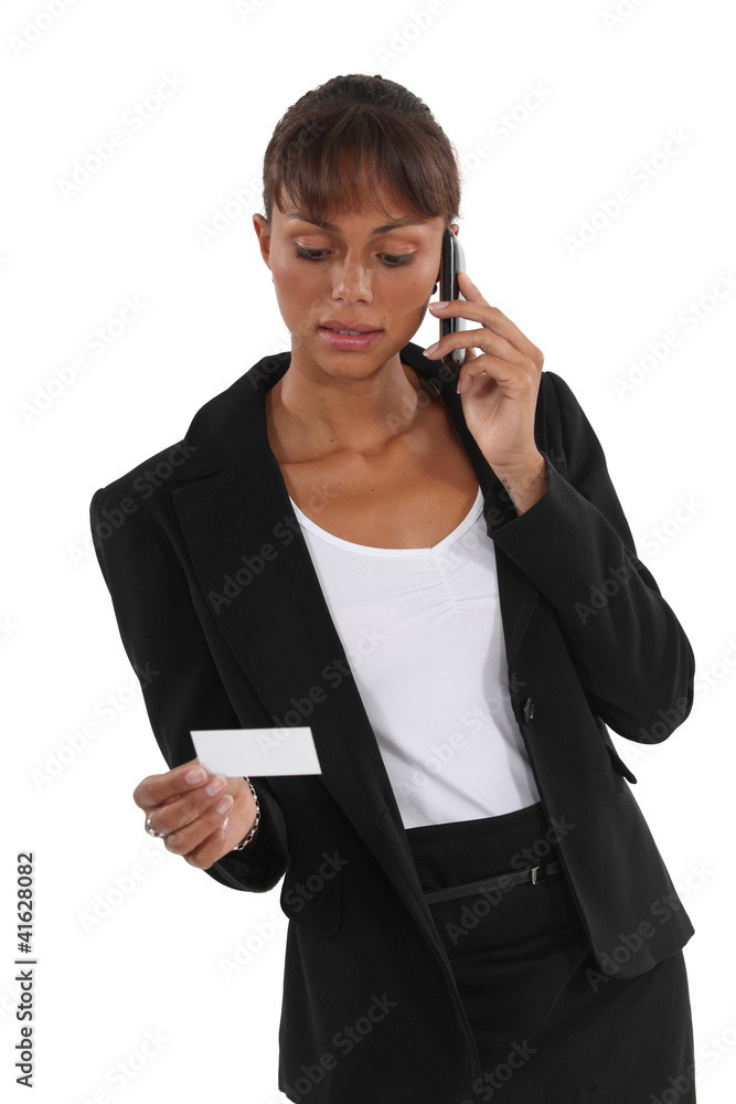 Businesswoman with a phone and a blank business card Businesswoman with a phone and a blank business card