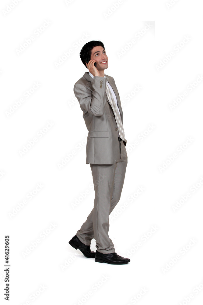 Businessman walking with a cellphone Businessman walking with a cellphone