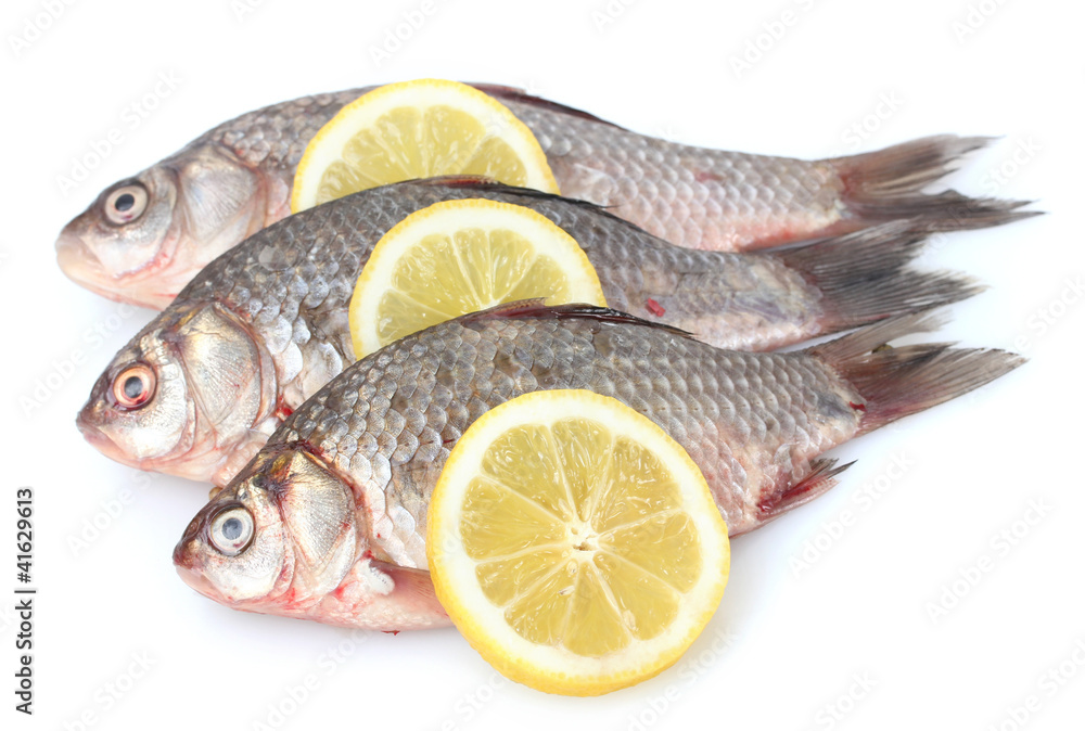 Fresh fishes with lemon isolated on white Fresh fishes with lemon isolated on white