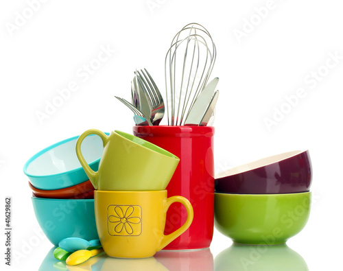 bright empty bowls, cups and kitchen utensils isolated on white