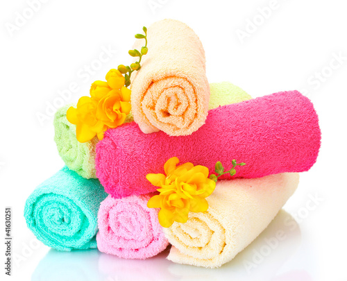 colorful towels and flowers isolated on white photo