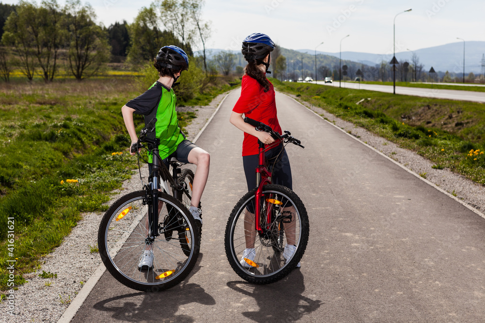 Fototapeta premium Girl and boy biking
