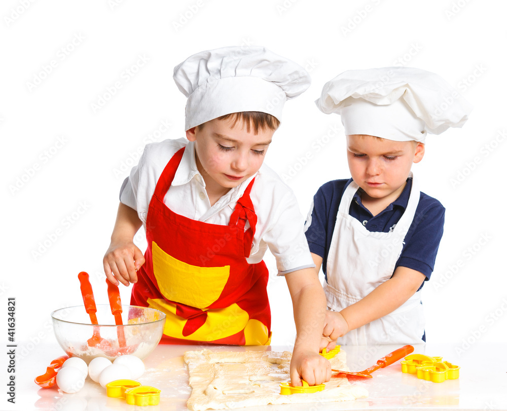 Two beautiful caucasian brothers making a cake Two beautiful caucasian brothers making a cake