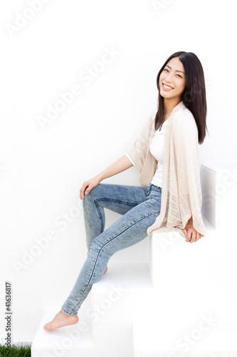 attractive young woman sitting on white stair