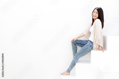 attractive young woman sitting on white stair
