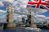 Tower Bridge with boat and flag of England in London
