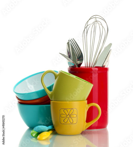 bright empty bowls, cups and kitchen utensils isolated on white