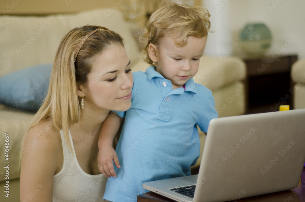 Beautiful young mother and son using a laptop Beautiful young mother and son using a laptop