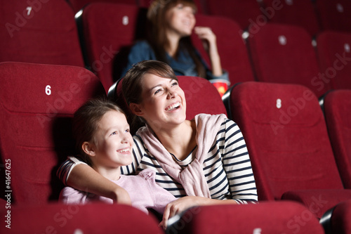 Loughing mother and daughter at the cinema