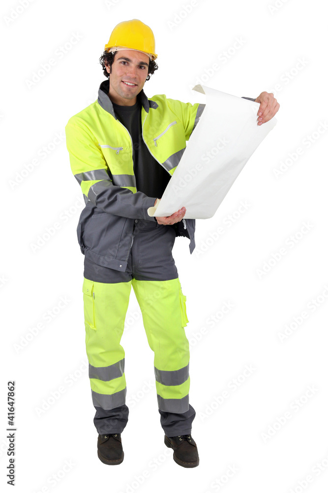 Foreman in reflective work-wear examining plans Foreman in reflective work-wear examining plans