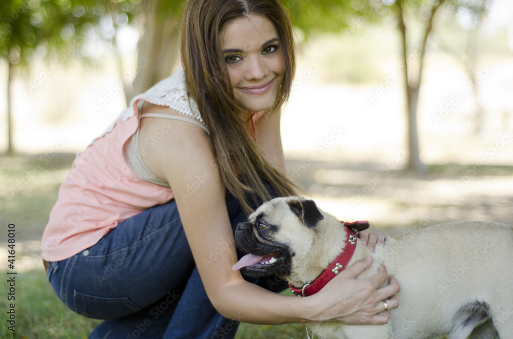 Beautiful woman with her pug dog at the park Beautiful woman with her pug dog at the park