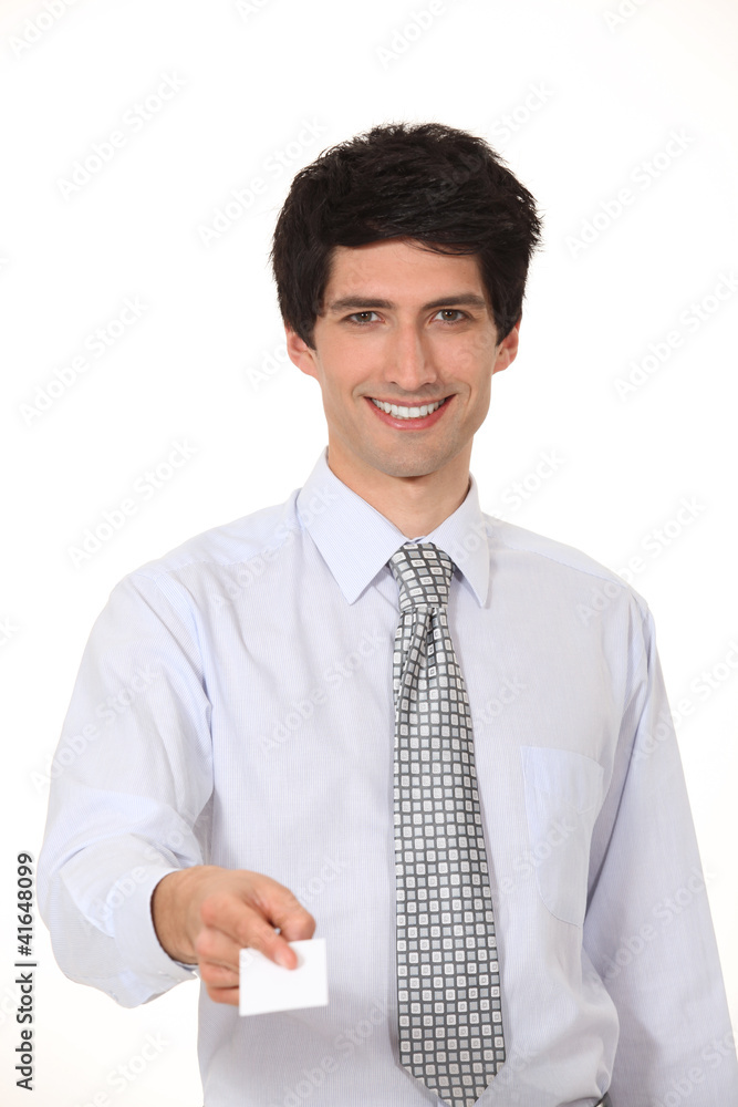 Smiling businessman offering his business card Smiling businessman offering his business card