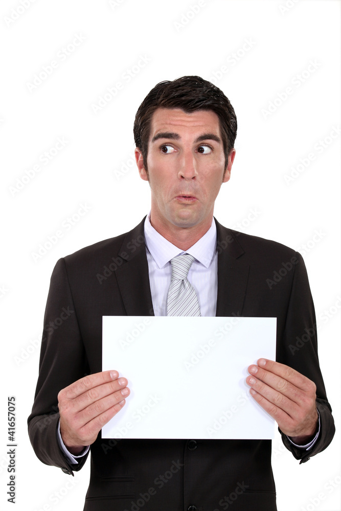Businessman presenting a poster with a weird expression. Businessman presenting a poster with a weird expression.