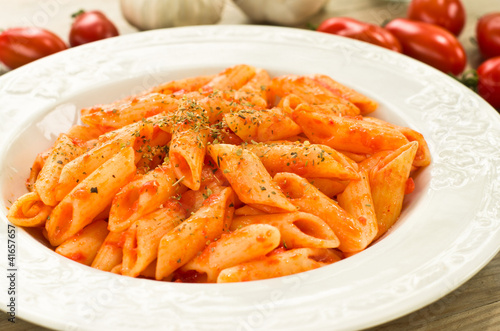 Penne pasta cooked with tomato sauce, garlic and oregano