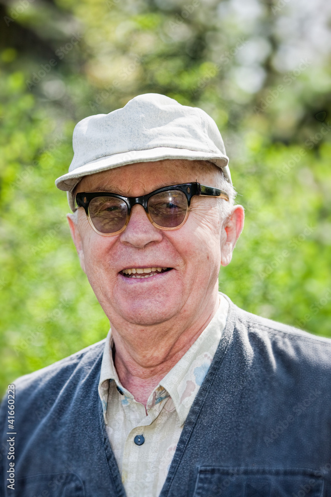 Senior happy man sitting in the park Senior happy man sitting in the park