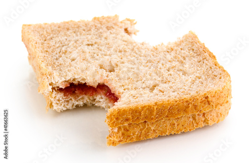 Bitten sandwich with jam isolated on white