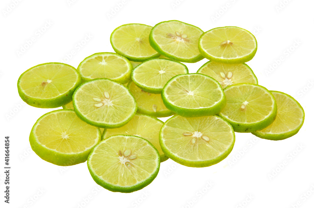 slices of lime piled on white background
