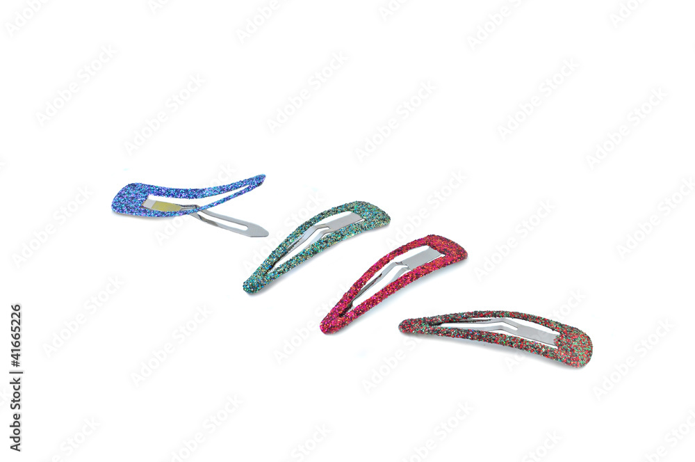 close up of colorful hair clips arranged on white close up of colorful hair clips arranged on white