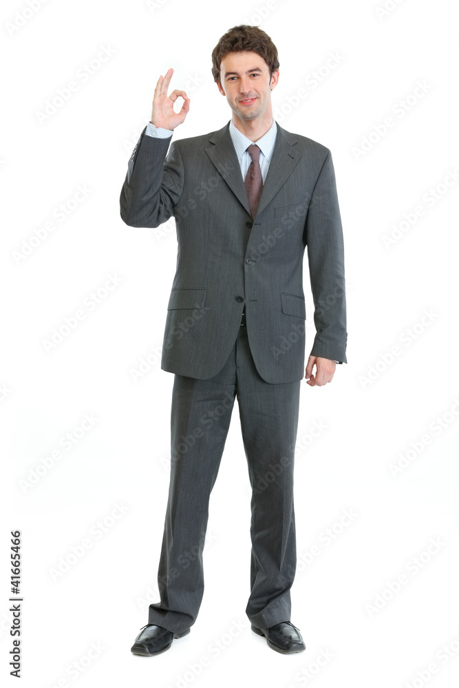 Full length portrait of businessman showing ok gesture Full length portrait of businessman showing ok gesture
