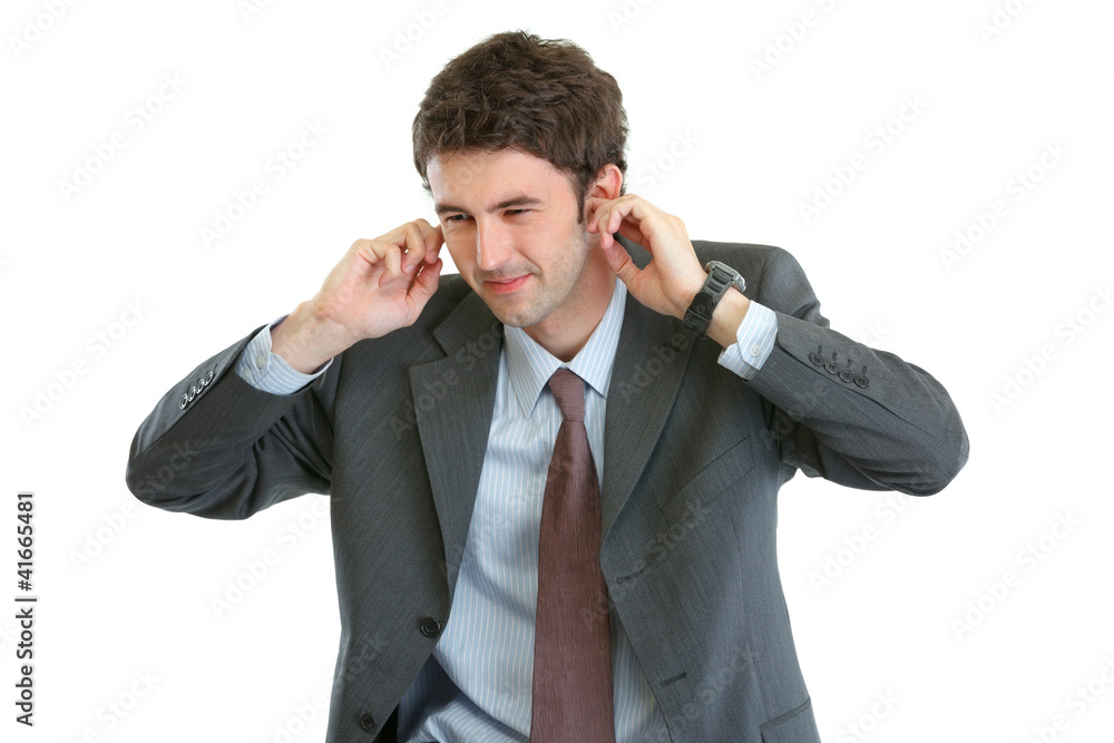 Portrait of scared businessman closing ears with fingers Portrait of scared businessman closing ears with fingers