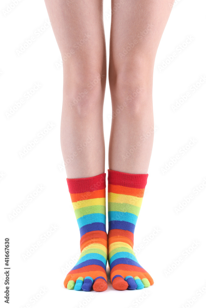 female legs in colorful striped socks isolated on white female legs in colorful striped socks isolated on white