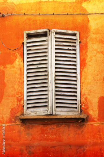 Shutters on orange wall