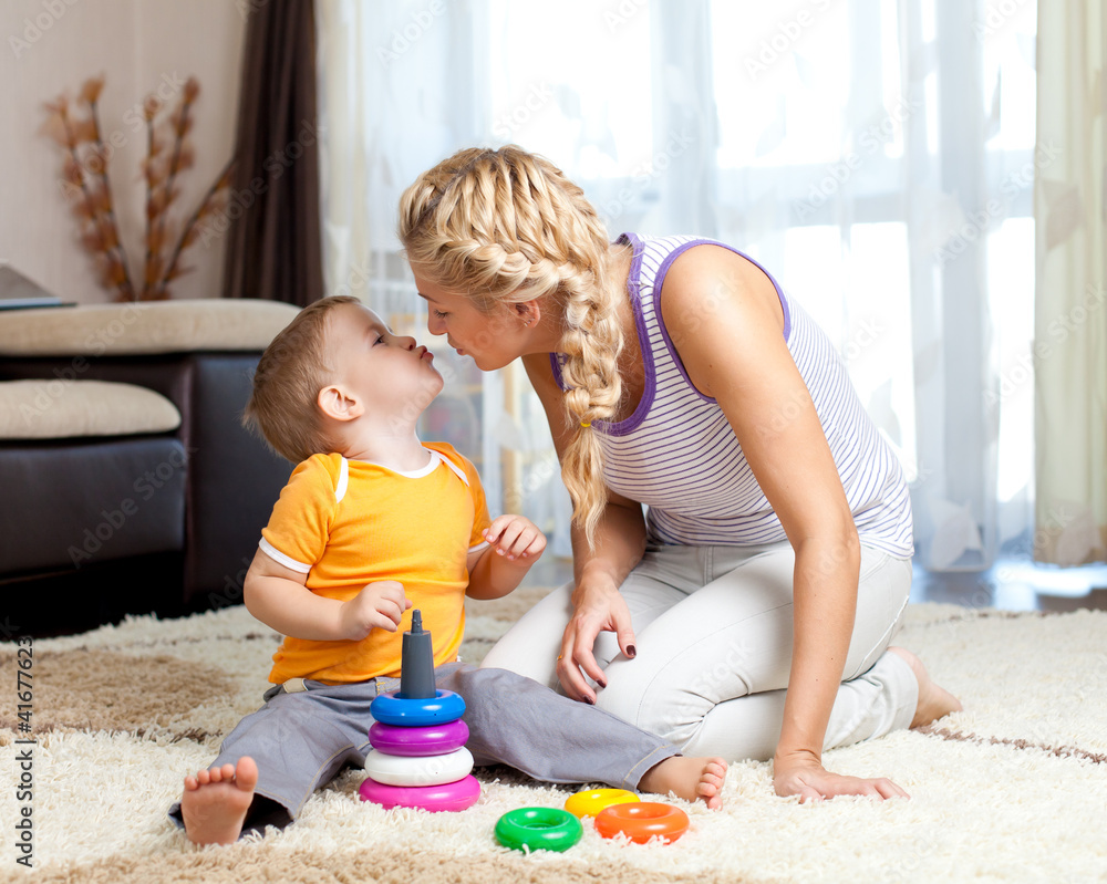 loving mother kissing her child boy together indoor loving mother kissing her child boy together indoor