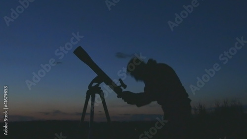 silhouette of telescope and astronomer