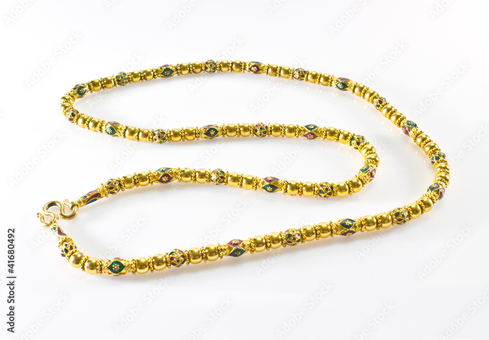 long gold necklace on a white background long gold necklace on a white background