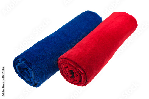 Two blue and red rolled up beach towel isolated photo