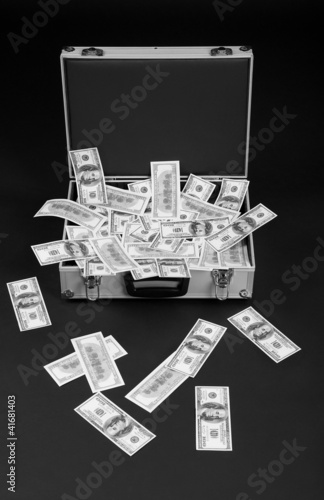 fallen money from full suitcase