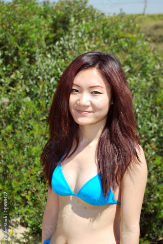 Portrait of Asian girl with bikini in the forest
