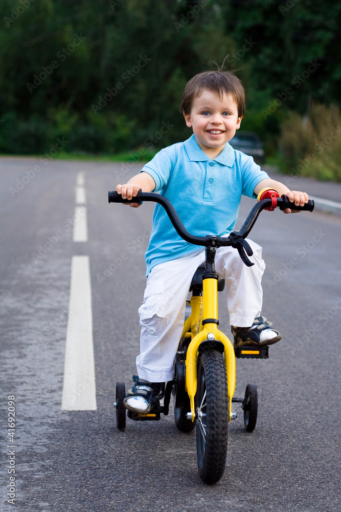 A little cyclist on the tour on the road A little cyclist on the tour on the road