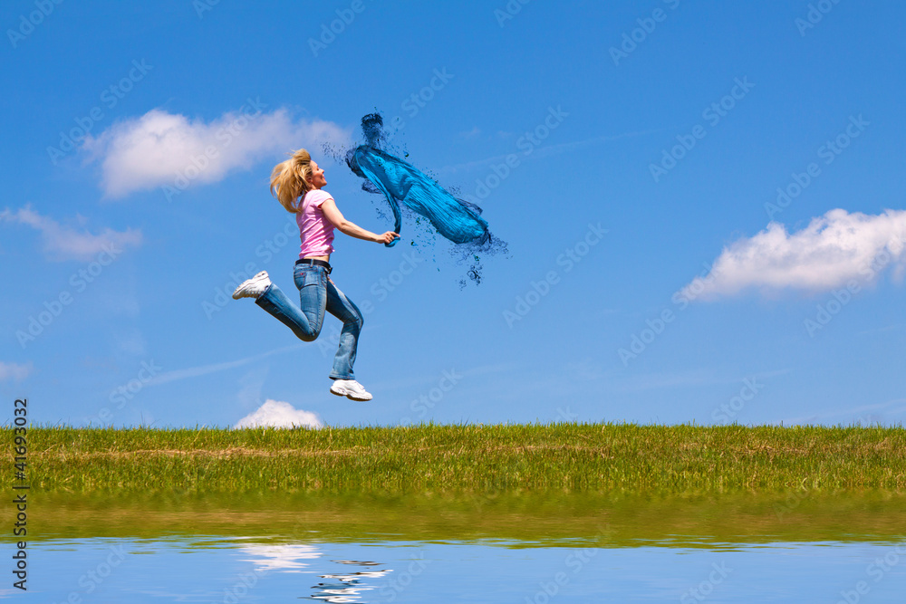 Woman jumps on the meadow