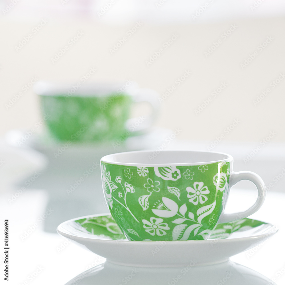 two cups of tea on a glass table two cups of tea on a glass table