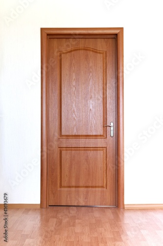 Brown door in white wall