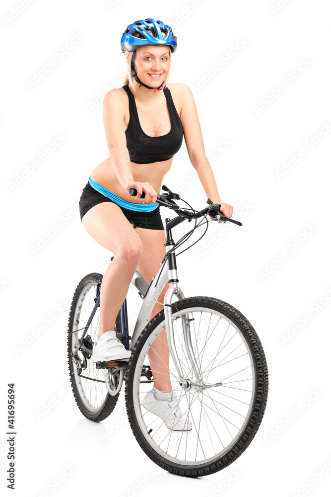 Portrait of a smiling female biker with helmet sitting on a bike Portrait of a smiling female biker with helmet sitting on a bike