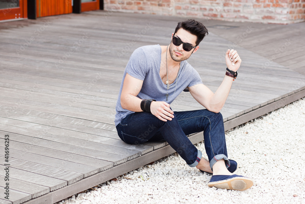 attractive young male model posing outdoors attractive young male model posing outdoors