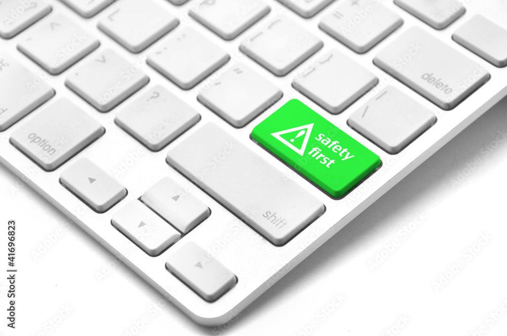 safety first concept with green key on computer keyboard safety first concept with green key on computer keyboard