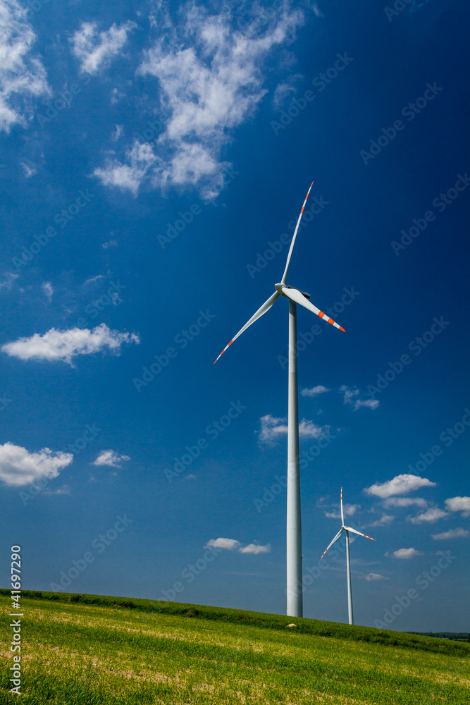 Wind Turbines on green field with blue sky Wind Turbines on green field with blue sky