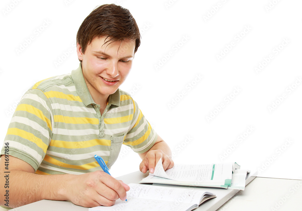A young guy studying, isolated on white, from above A young guy studying, isolated on white, from above