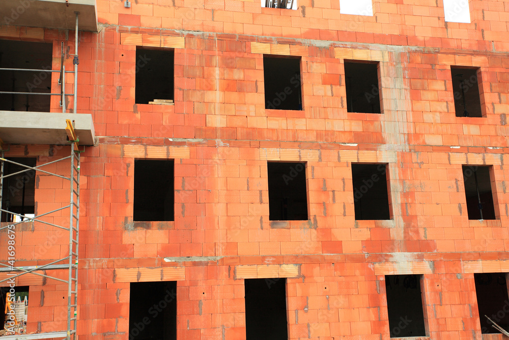 residential building under construction in red brick